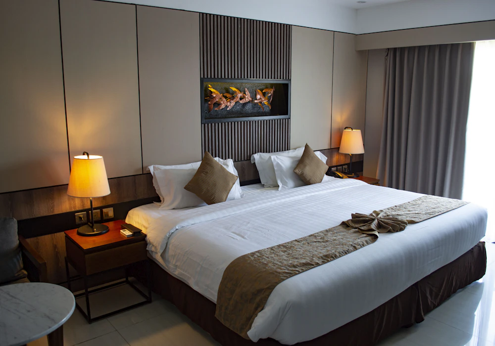 A calm, contemporary hotel room with space to work and rest
