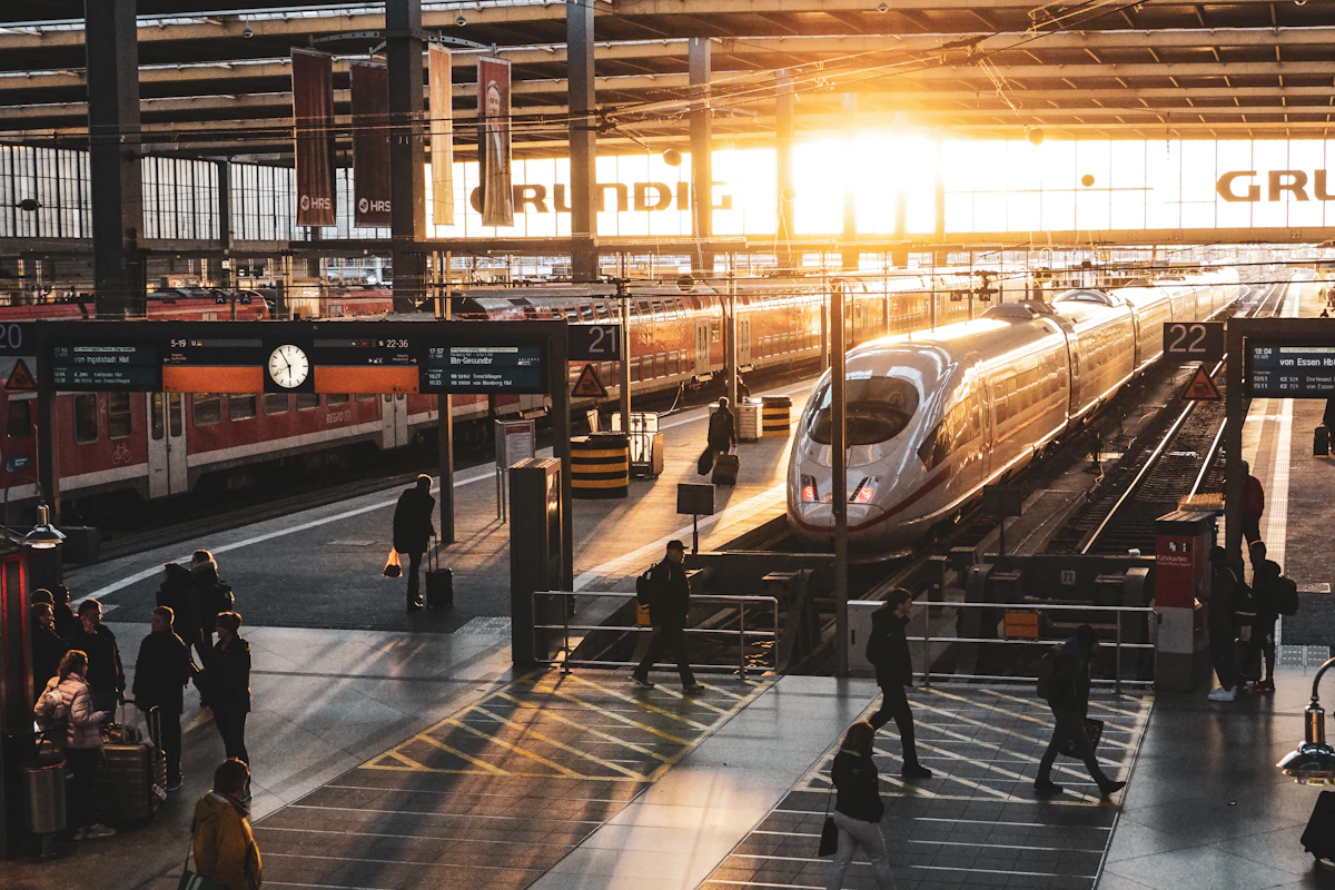 Travellers and high-speed trains at a modern railway station